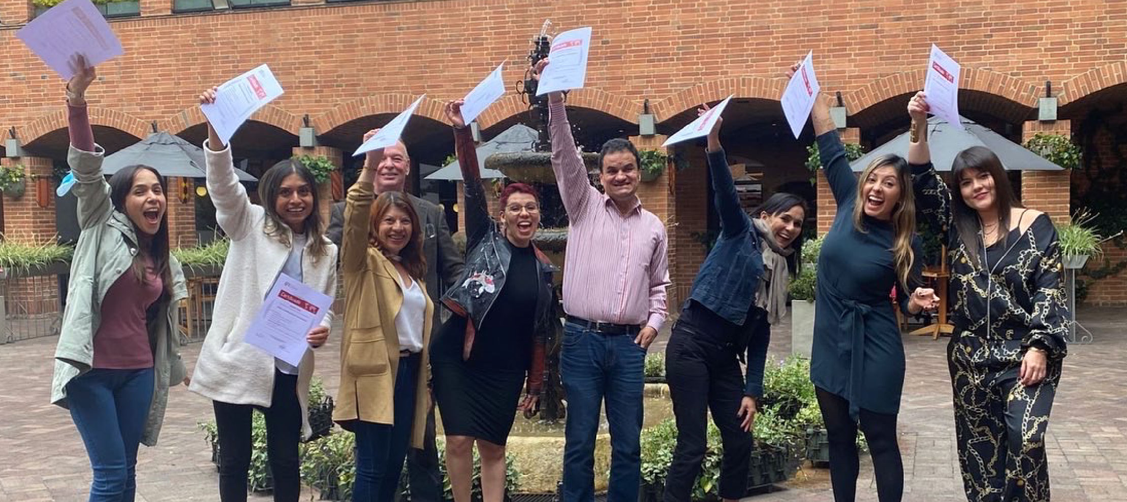 Equipo técnico de APC-Colombia, celebrando ante la cámara con certificados del proceso de consultoría en Cooperación Internacional que realizaron con GIZ