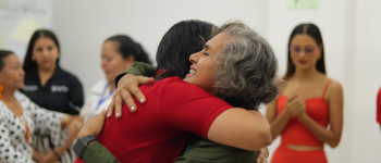 Abrazo de dos participantes del Col-Col sobre rutas de memoria alrededor del turismo comunitario en Caquetá